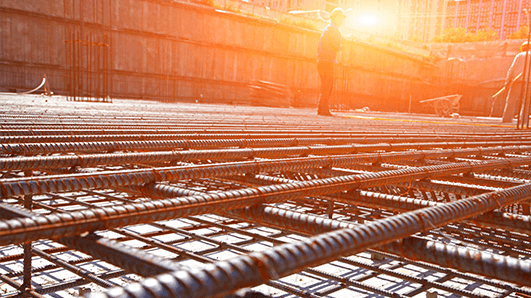 Construction site at sunset with person in hard helmet